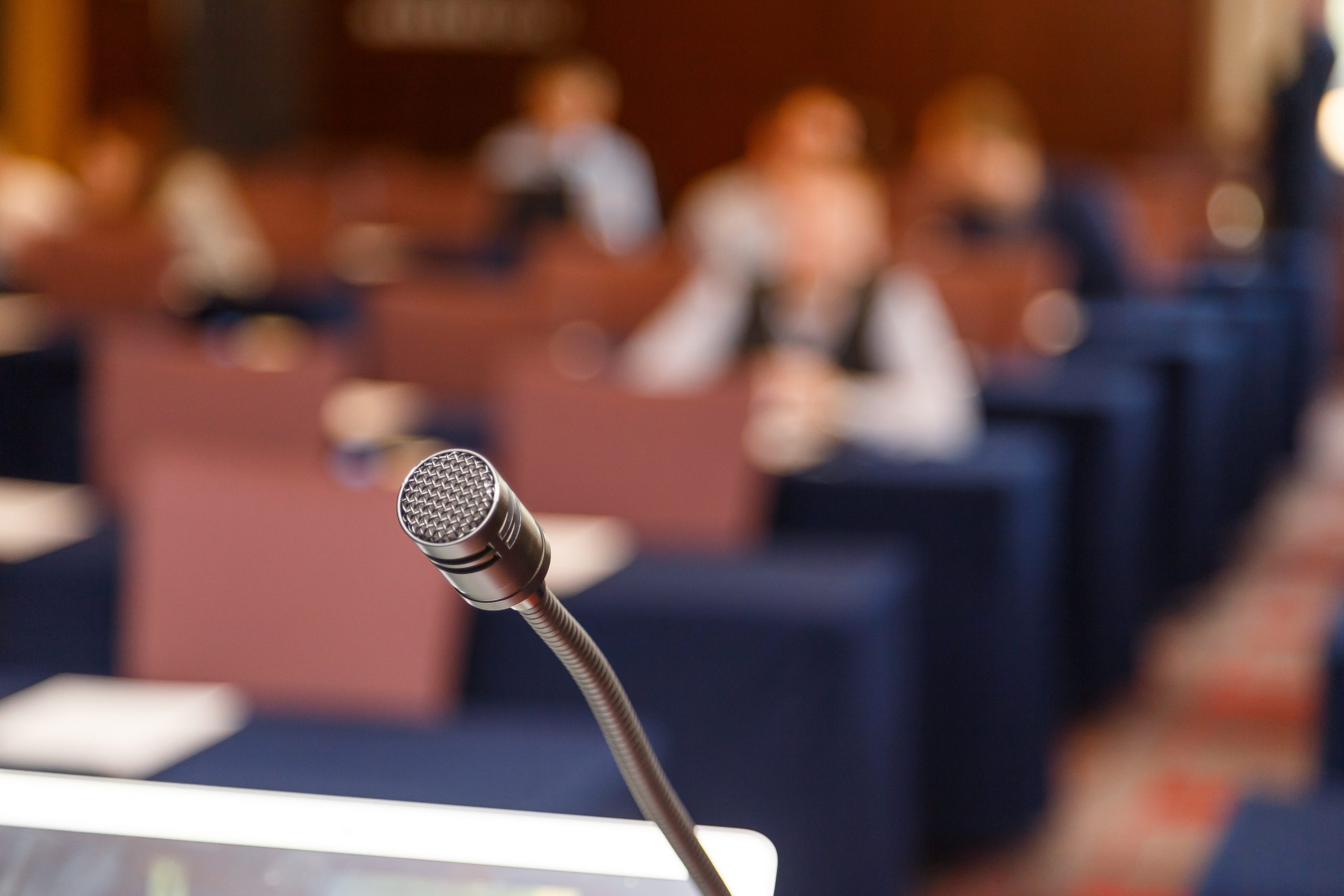 A microphone in front of a conference hall